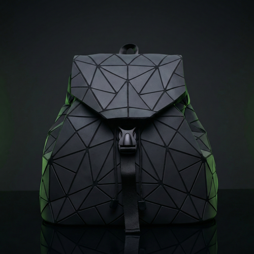 Geometric backpack with black and green design on a dark background